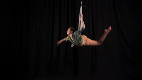 Flexible athletic circus gymnast performs acrobatic elements on the air ring Stock Footage 131273514