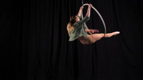 Flexible athletic circus gymnast performs acrobatic elements on the air ring Stock Footage 131273861