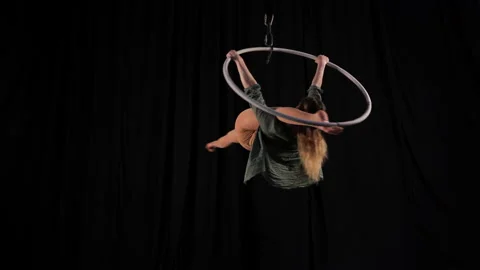 Flexible athletic circus gymnast performs acrobatic elements on the air ring Stock Footage 131274160