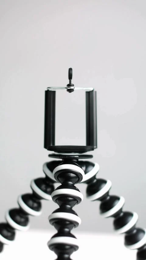 Flexible black and white tripod stands on white background Stock Footage 331769966