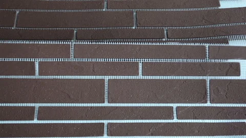 Flexible brick, clinker, on a reinforced mesh, for finishing house facades Stock Footage 323116827