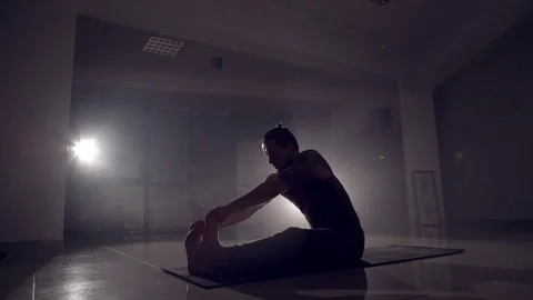 Flexible man stands on his hands in a gym. Stock Footage 72942871
