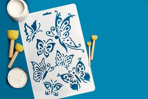 Flexible plastic stencil for graphical design, white paint and foam brushes Stock Illustration