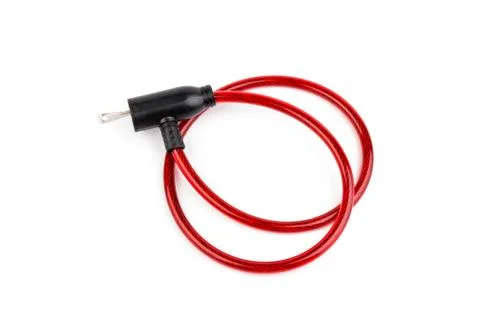 Flexible red bicycle cable with key on white background.  Security and safety Stock Photos