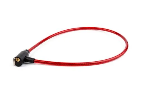 Flexible red bicycle cable with key on white background.  Security and safety Stock Photos
