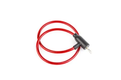 Flexible red bicycle cable with key on white background.  Security and safety Stock Photos