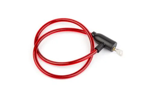 Flexible red bicycle cable with key on white background.  Security and safety Foto stock