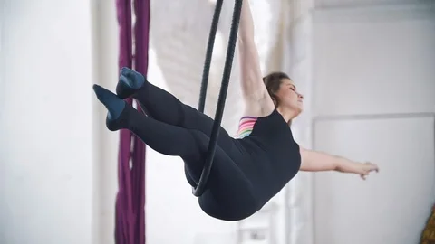 Flexible woman makes a gymnastic elements on the aerial hoop Stock Footage 87978722