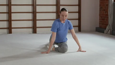 Flexible Woman Practicing Stretching Exercises for Legs, Arms and Back Stock Footage 311939331
