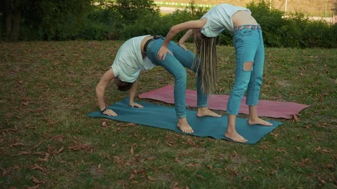 Flexible young couple doing different asanas practising yoga training class Stock Footage 117569050
