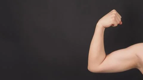 The Flexing or Strong Arm Hand Sign on black background. Stock-Fotos