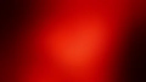 The flicker of a red light with a black vignetting. Blurry burgundy color with Stockbeeldmateriaal 234814841