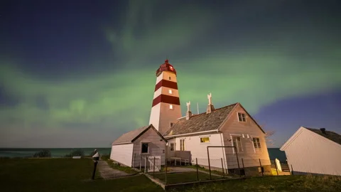 Flickering aurora borealis over lighthouse Stock Footage 250764717