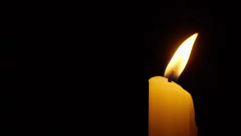 Flickering candle flame on black background Stock Footage 345022361