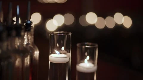 Flickering Candles Set Tranquil Mood, Tiered Glass Candle Holders Emit Soft Stock Footage 323770908
