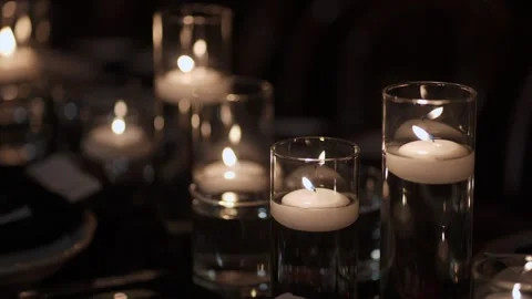 Flickering Candles Set Tranquil Mood, Tiered Glass Candle Holders Emit Soft Stock Footage 323772506