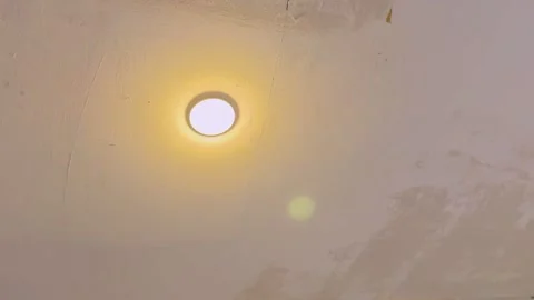 Flickering Ceiling Light Bulb on Indoor Plaster Ceiling Stock Footage 331633310