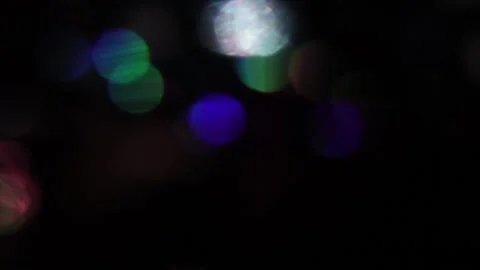Flickering colored bokeh on a dark background 库存影片 317448203