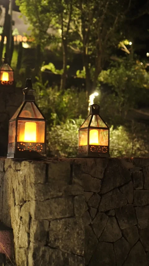 Flickering Electric Lanterns on Stone Wall at Night – Candlelight Effect Stock Footage 313686164