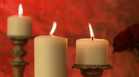 Flickering flame of candles on red background Stock Footage 44021291