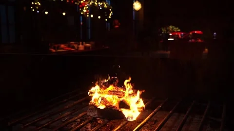 Flickering flames in a cozy setting, camera pans to reveal warm ambiance Stock Footage 322976730