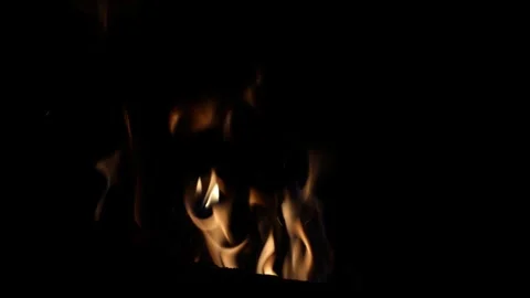 Flickering flames dance, illuminating swaying shadows, devouring the wood with Stock Footage 287530529