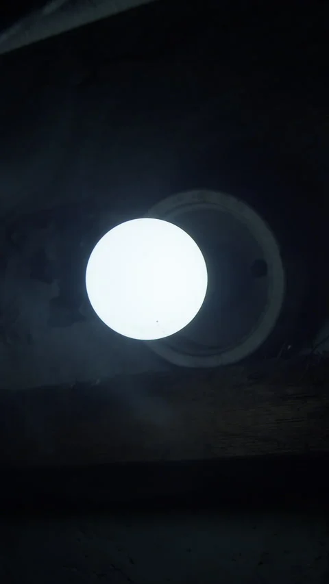 Flickering glowing light bulb center frame in dark cellar noir Stock Footage 332634410