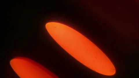 Flickering highlights of orange light in oval diagonal bokeh 4k Stock Footage 234405449