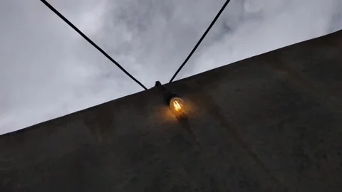 A flickering light bulb against a dirty wall. Stock Footage 326709014