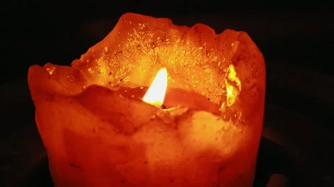 Flickering light from a burning candle in the wind of an open flame Stock Footage 131220396