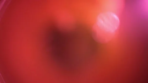 Flickering light from an orange lens on a black background 4k Stock Footage 132023838
