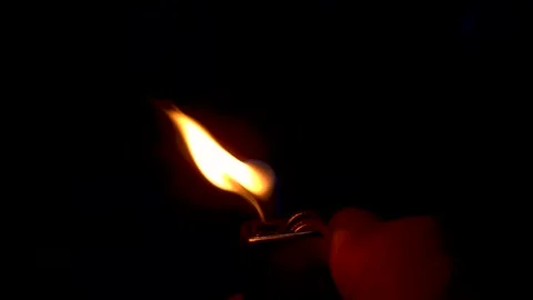 Flickering Lighter Flame Blown by Wind in Dark Background | Dynamic Fire Close Stock Footage 331997960