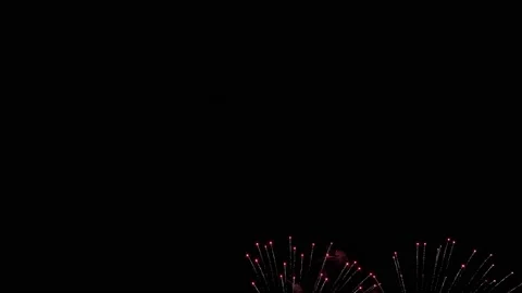 Flickering lights and flashes of fireworks in the night sky on a black backgroun Video stock 117824311