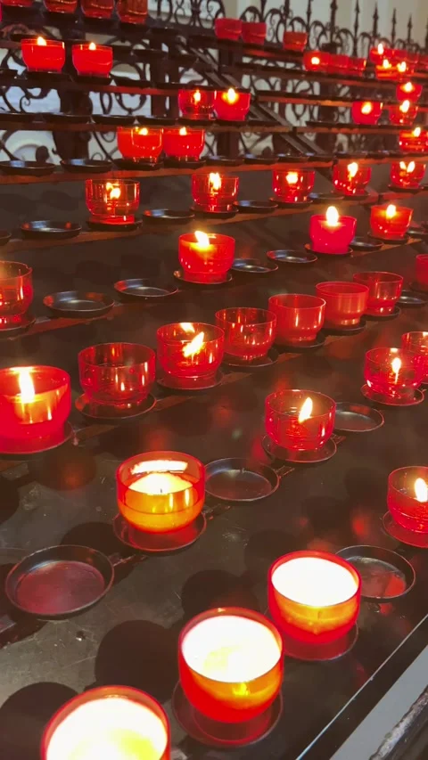 Flickering Red Candles Create a Warm Atmosphere in a Serene Space for Reflection Stock Footage 319984557