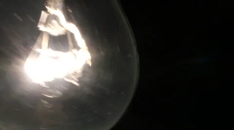 Flickering swinging electric light bulb Stock Footage