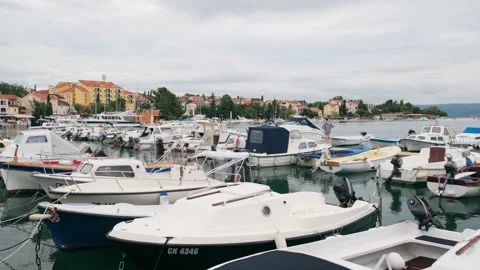Flies back low over multi-colored fishing boats in the gulf of the Mediterranean Stock Footage 134655004