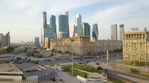Flies beautifully between ancient buildings overlooking modern skyscrapers Stock Footage 163671721