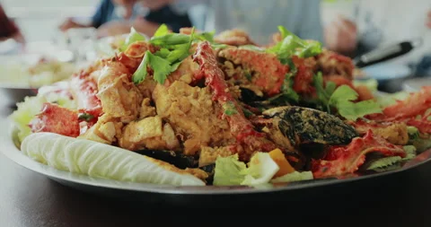 Flies flying around cooked mixed seafood in the large plate Stock Footage 287545206