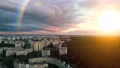 The flight above a city on the rainbow background. quadrocopter shot. time lapse 4k or 4k+ Resolution