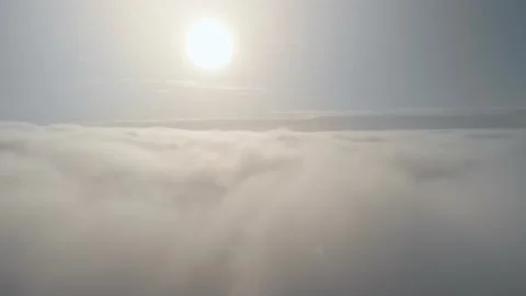 Flight above the clouds in an airplane, with a bright sun that illuminates the Stock Footage 172344379