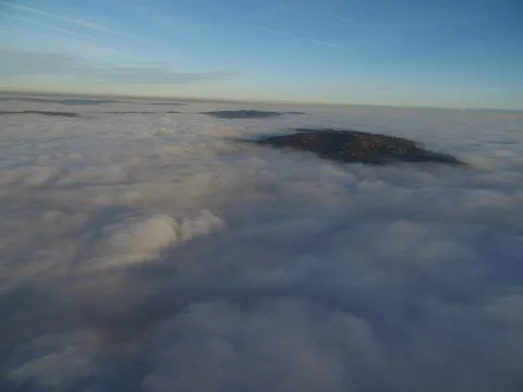 Flight above clouds through the cloudy sky Stock Photos