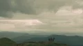 The flight above the four active people on the mountain 4k or 4k+ Resolution