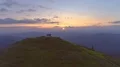 The flight above four people on the mountain top against the sunrise 4k or 4k+ Resolution