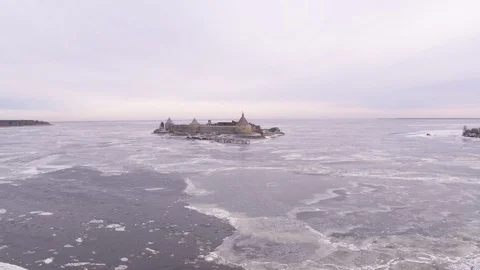 Flight above frozen sea with old fortress 動画素材 123768623
