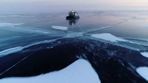 Flight above ice boat hovercraft at sunset rides on winter Baikal lake Siberia Video stock 165216001