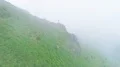 The flight above the man standing on a mountain cliff 4k or 4k+ Resolution