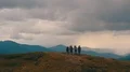 The flight above the mountain with four active people 4k or 4k+ Resolution