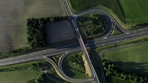 Flight Above A Multi-Level Junction Road Surrounded By Green Fields Stock Footage 142009442