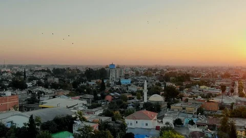 Flight above Muslim town with mosque minaret and residential buildings. Video stock 100456433