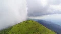 The flight above a picturesque mountain on the cloud background 4k or 4k+ Resolution